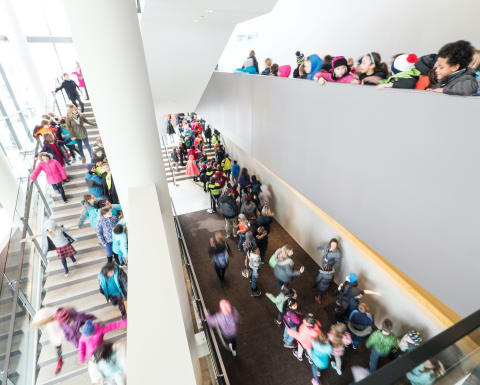 Bird-eye-view inside Orchestra Hall full of students before a concert