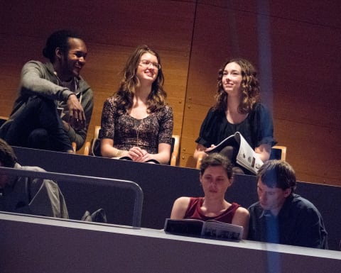 Young adults talking in their seats before a performance