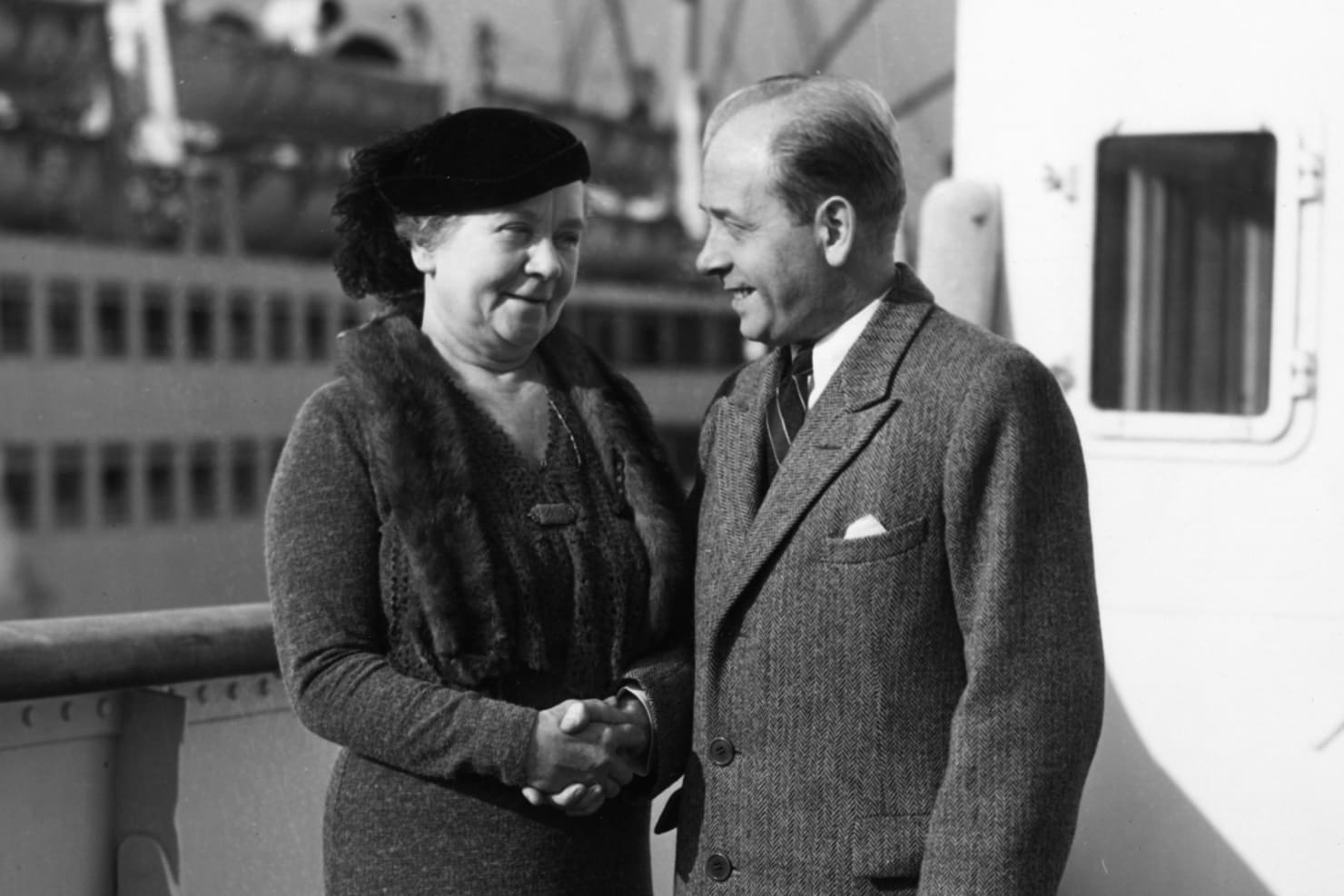 Eugene Ormandy shaking hands with Mrs Carlyle Scott