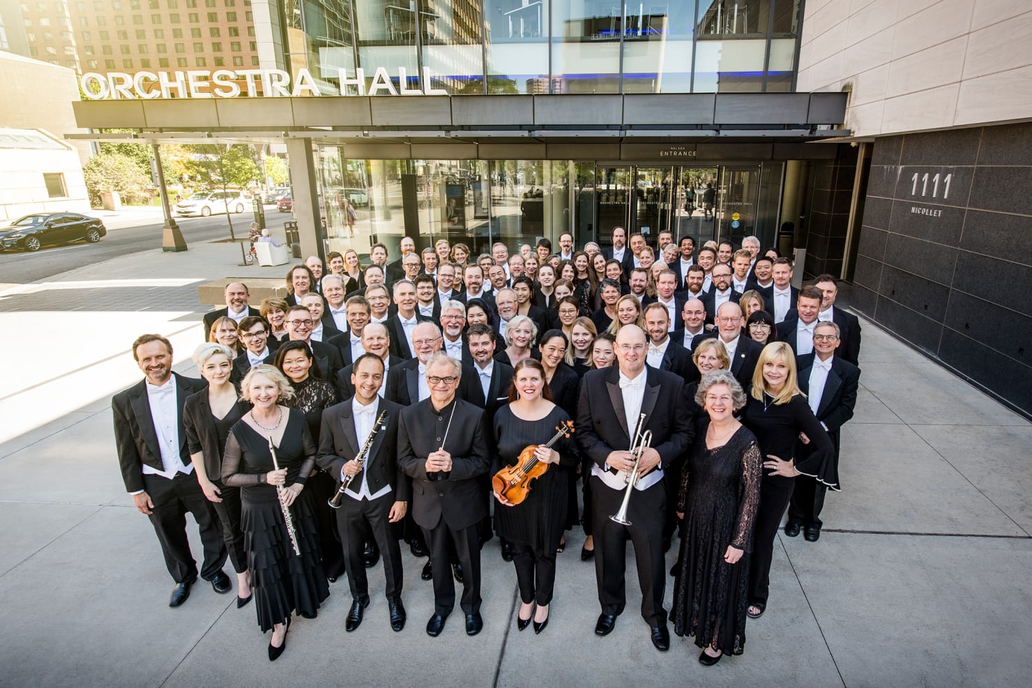 Minnesota Orchestra standing in a group outside of Orchestra Hall