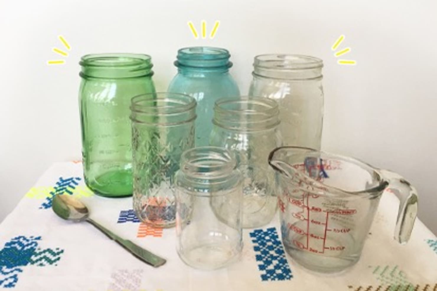 Colorful jars and a measuring cup