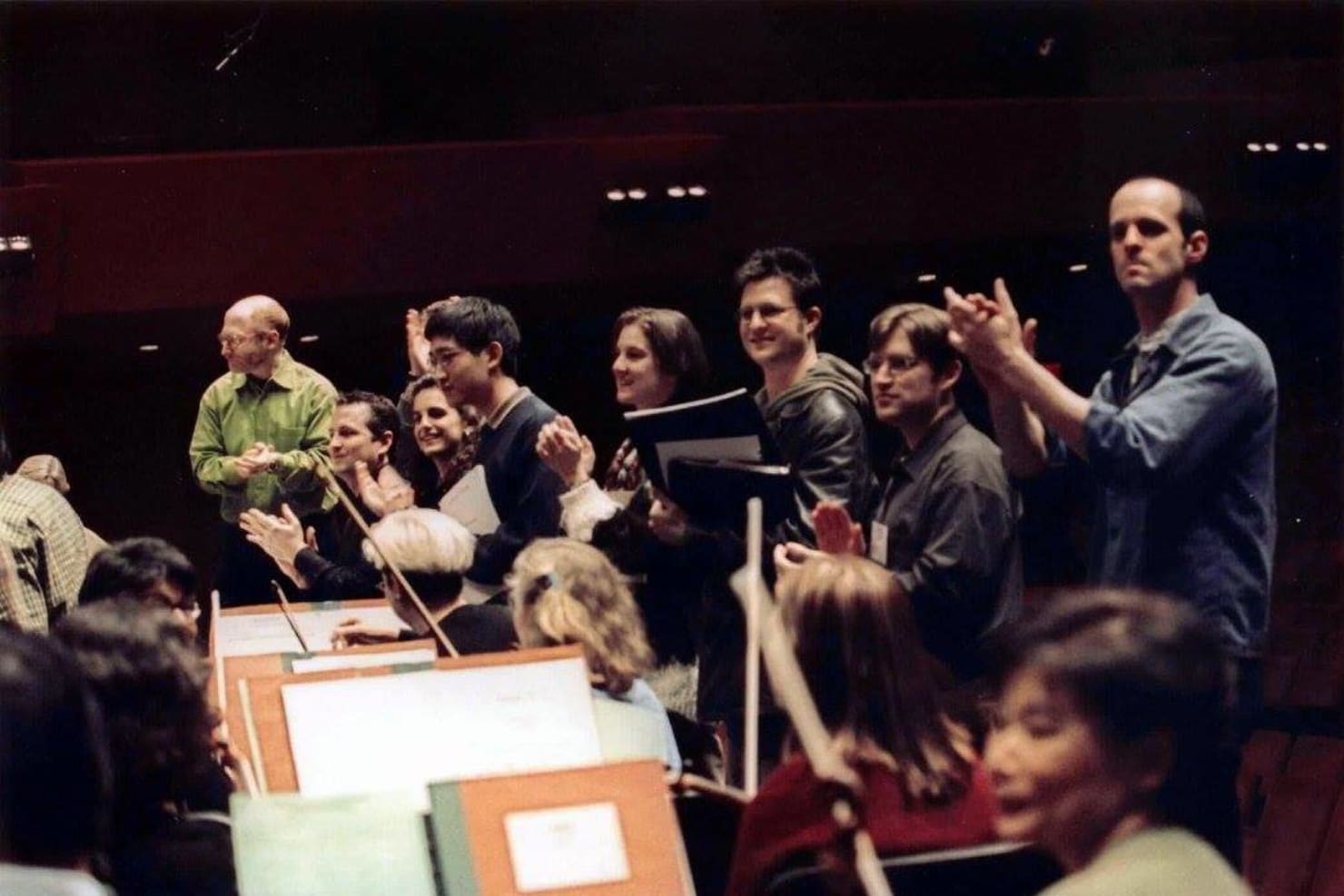 The inaugural Minnesota Orchestra Composer Institute's particpants Gordon Beeferman, Lisa Bielawa, Anthony Cheung, Stacy Garrop, Michael Gatonska, Keith Murphy, Stephan Prock and Mischa Zupko, applauding the Minnesota Orchestra.