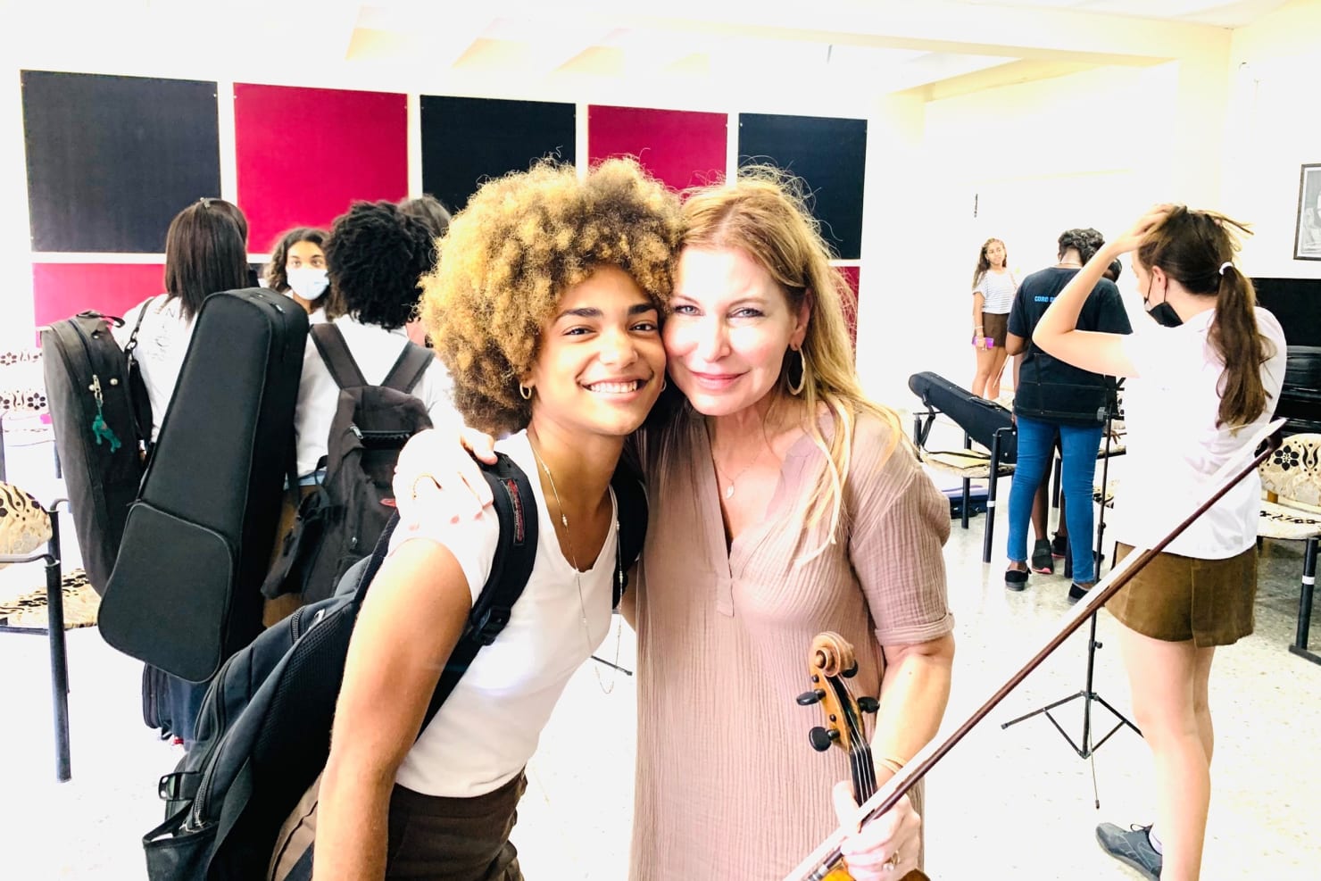 Violinist Milana Elise Reiche with a young violinist at Escuela Nacional de Arte in Havana.