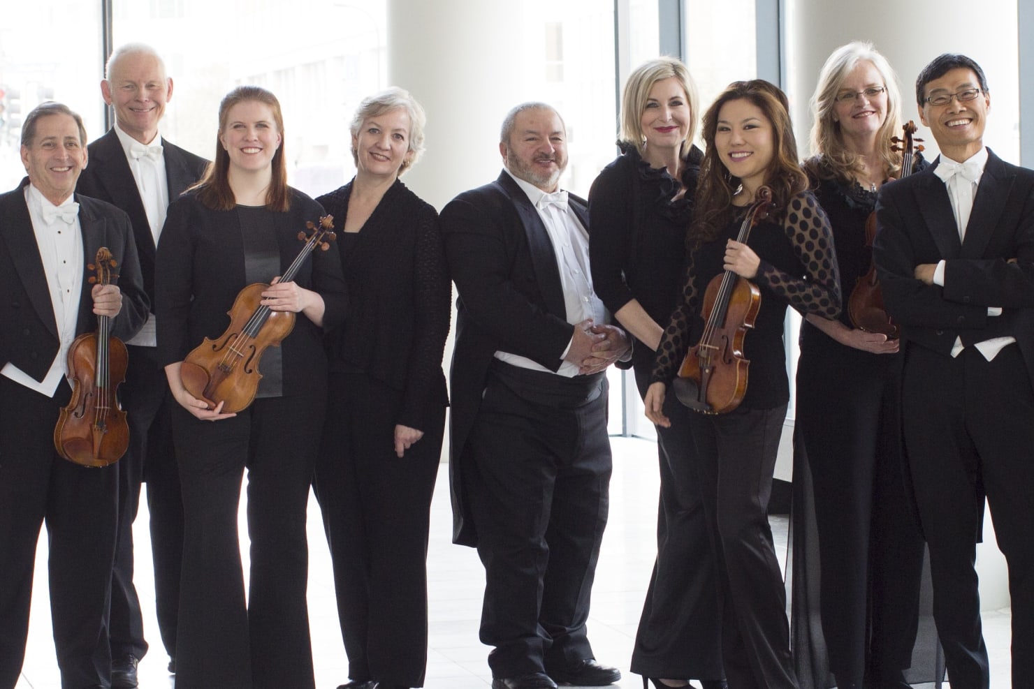 Rudolf Lekhter, center, with violin section colleagues in the Orchestra Hall lobby