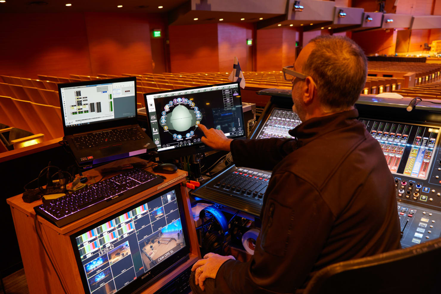 Jay Perlman gestures to his computer monitor, which displays a head with different points of perspective from which Jay can direct the audio experience