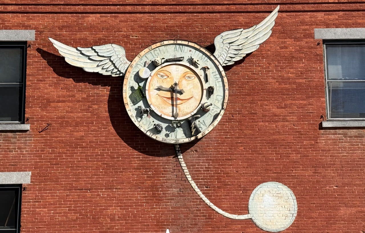 A peculiar clock on the wall outside the Old Brick Store
