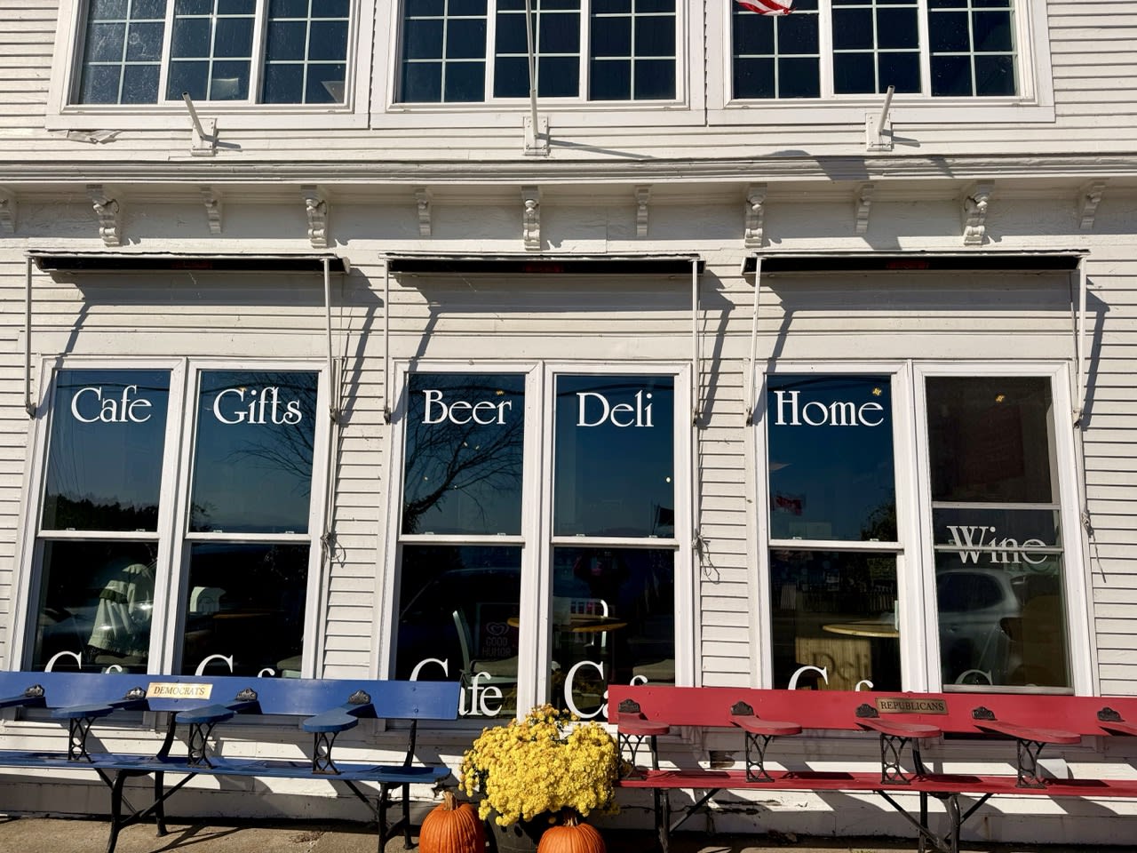 A pair of benches outide Hero's Welcome general store labeled 'Democrats' and 'Republicans'