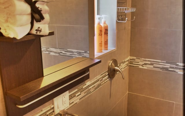 Alessandro's listing on misterb&b - The bathroom features a spacious shower, soaps, shampoo and conditioner along with storage and a hairdryer.