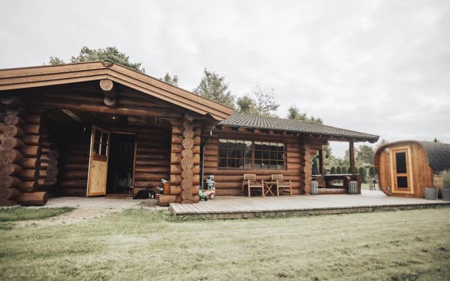 Genuine and authentic log house near water, fjord and forest