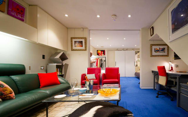 Jeff's listing on misterb&b - Living room looking towards the bedroom.  The red chairs were made by the Jaguar Car Company