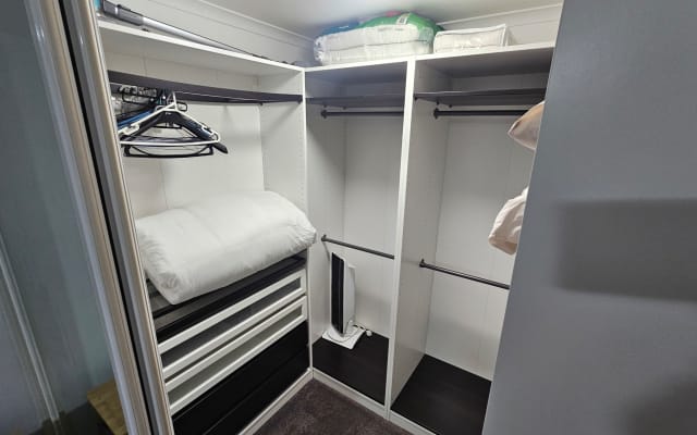Val's listing on misterb&b - The walk-in robe contains ample space, a heater, and a comforter for the sofa bed in the living room 