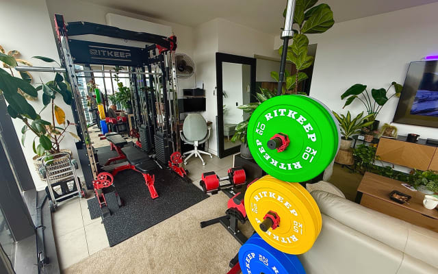 Jason's listing on misterb&b - Home gym with smith machine and barbell with 100kg of weight plates. 2x 75kg cables, adjustable dumbbells 4kg-32kg, adjustable bench and a heap of accessories. 
