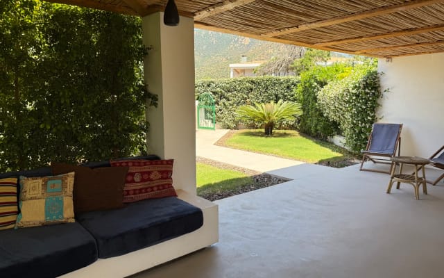 Bright modern villa with manicured garden near sandy beach
