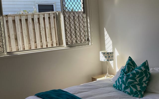 Light filled room with queen bed with separate private shower & wc