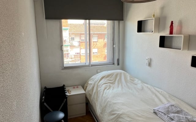 Room with AC; shared bathroom, kitchen, and dining room.