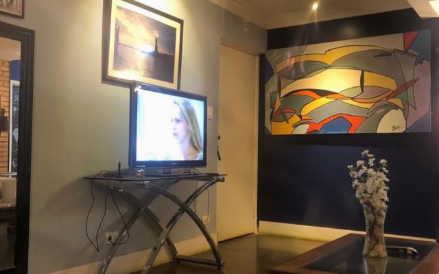 Sergio's listing on misterb&b - TV room equipped with 40-inch TV, integrated with American kitchen, living room and balcony.