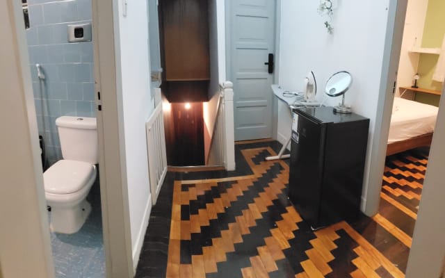 Carlos's listing on misterb&b - Full bathroom, staircase leading to the second floor of the house, guest rooms, ironing area, minibar, concave hand mirror, ideal for applying make-up.