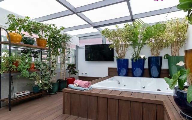 Marcos's listing on misterb&b - Jacuzzi in the garden area of the apartment. Comfortable for 4 people. Smart TV in the background.