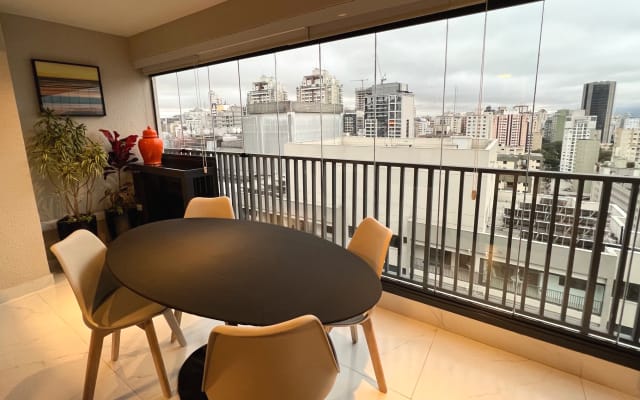 Marcos's listing on misterb&b - Dining table next to glass curtain overlooking the 25th floor. We've put up a safety screen.