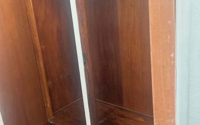 Room with a single bed, a workstation, and a private bathroom