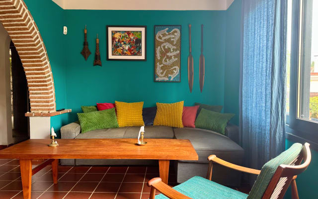 A comfortable room in a cozy house surrounded by a garden.