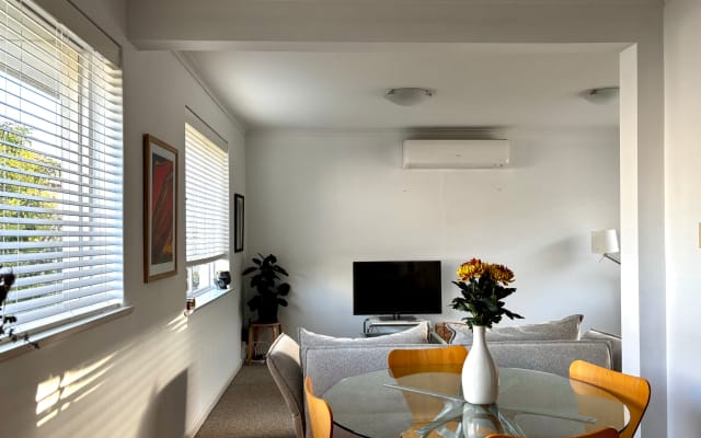 Bedroom in sunlit apartment near Yarra river