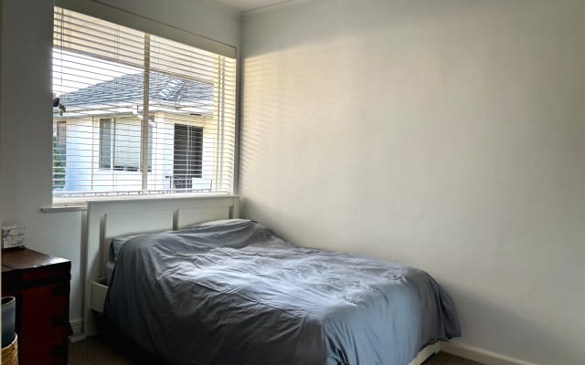 Bedroom in sunlit apartment near Yarra river