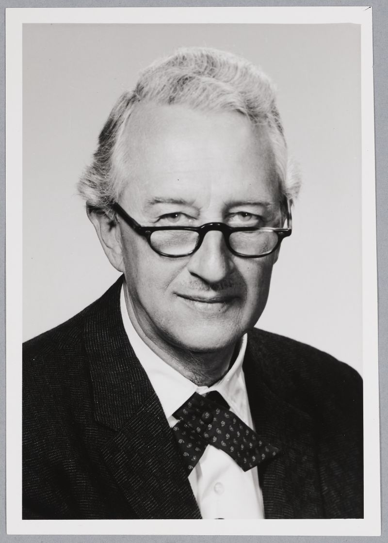 Frank Conant, man wearing glasses in a suit