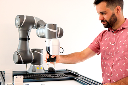 Man working with OMRON collaborative robot