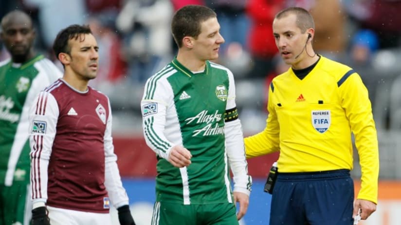 Referee Mark Geiger talks to Will Johnson (Portland Timbers)