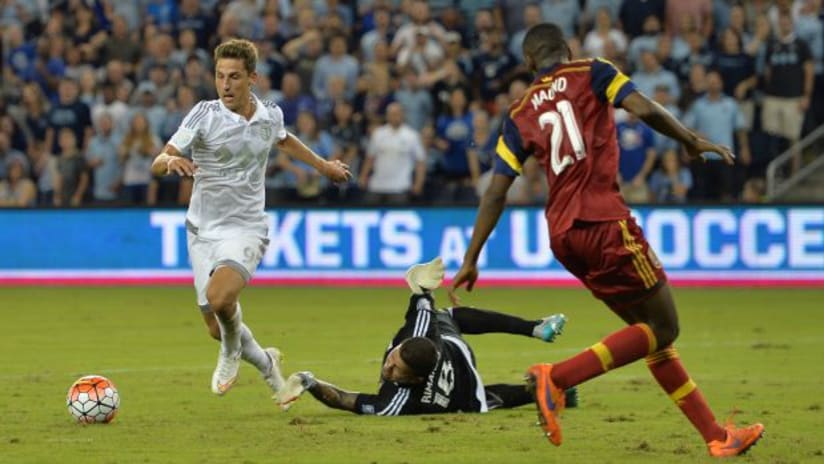 Krisztian Nemeth (Sporting Kansas City) attempts to elude Nick Rimando and Aaron Maund (Real Salt Lake)