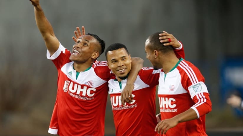 Charlie Davies, Juan Agudelo and Teal Bunbury celebrate for the New England Revolution