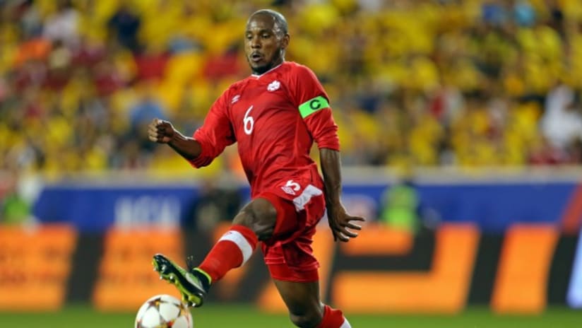 Canada's Julian De Guzman brings down a ball vs. Colombia