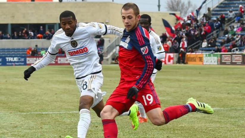 Harry Shipp tries to hit a ball while Ray Gaddis watches on