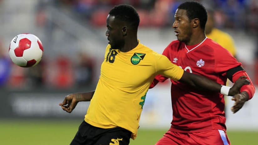 Simon Dawkins of Jamaica and Patrice Bernier of Canada in an international friendly