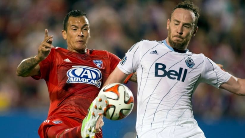 Blas Perez (FC Dallas) and Andy O'Brien (Vancouver Whitecaps) battle for a ball in 2014 playoffs