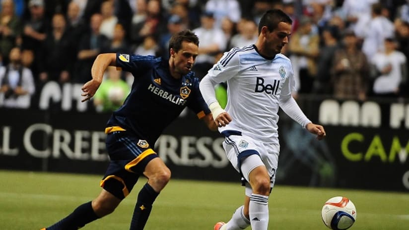 LA Galaxy's Todd Dunivant goes up against Vancouver Whitecaps' Octavio Rivero