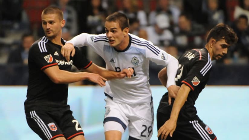 DC United midfielder Perry Kitchen marks Whitecaps forward Octavio Rivero