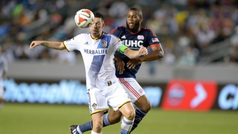 LA Galaxy's Robbie Keane tries to fend off New England Revolution's Andrew Farrell