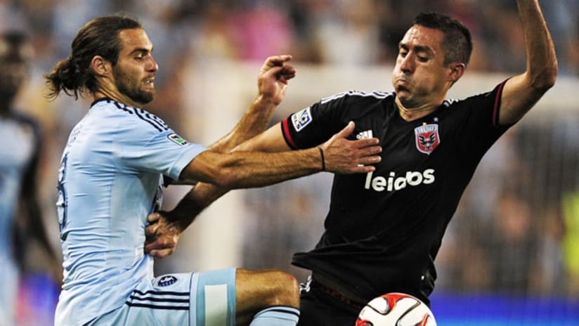 Graham Zusi and Davy Arnaud do battle at Sporting Park