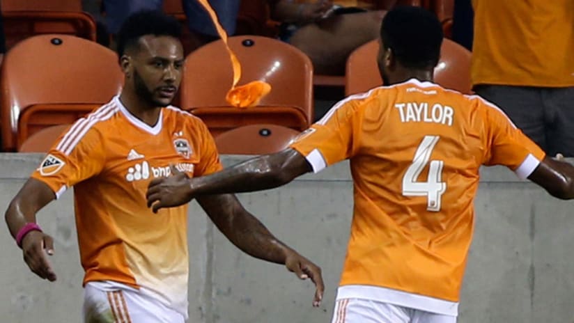 Giles Barnes celebrates a goal for the Houston Dynamo with Jermaine Taylor