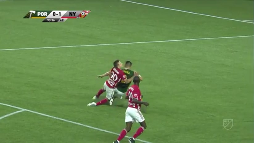 PENALTY: Jorge Moreira slides into Marc Rzatkowski in the box