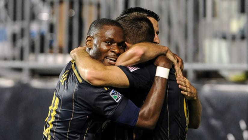 Maurice Edu, Andrew Wenger and Sebastien Le Toux embrace