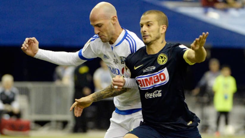 Laurent Ciman defends on Dario Benedetto in CCL final 2015