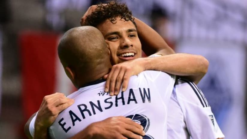 Robert Earnshaw hugs Vancouver Whitecaps teammate Kianz Froese after the latter scores a goal