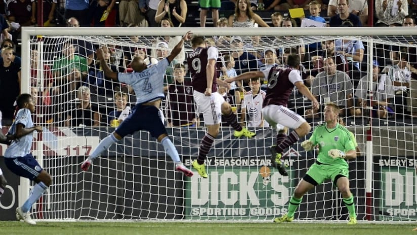 Kevin Doyle (Colorado Rapids) scores the go ahead goal past Sporting KC defender Kevin Ellis