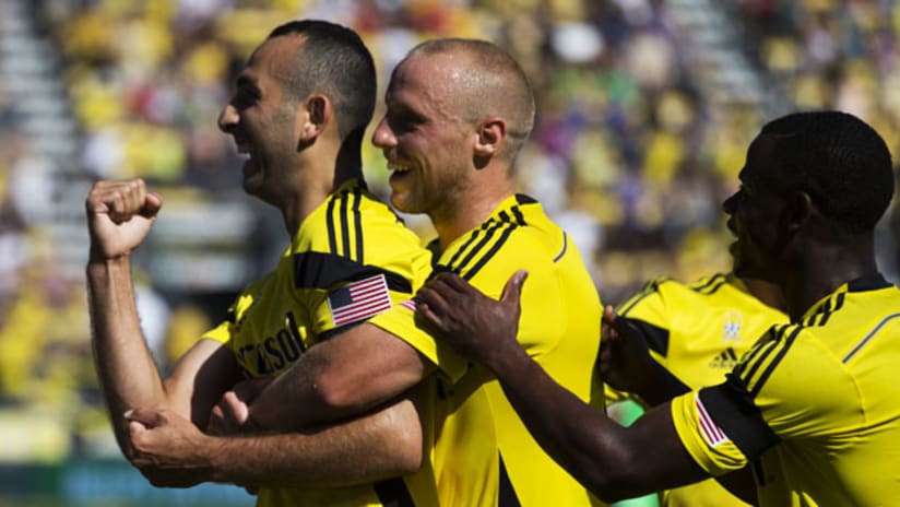 Justin Meram celebrates with Columbus Crew teammates.