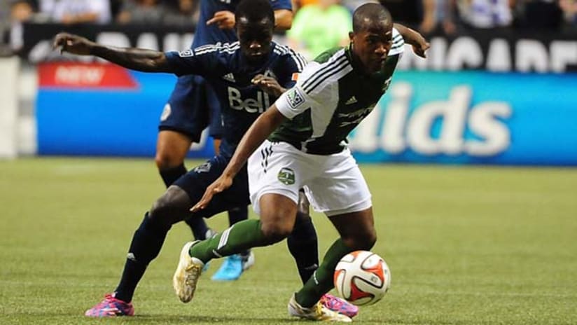 Darlington Nagbe (Portland Timbers) dribbles past Kekuta Manneh (Vancouver Whitecaps)