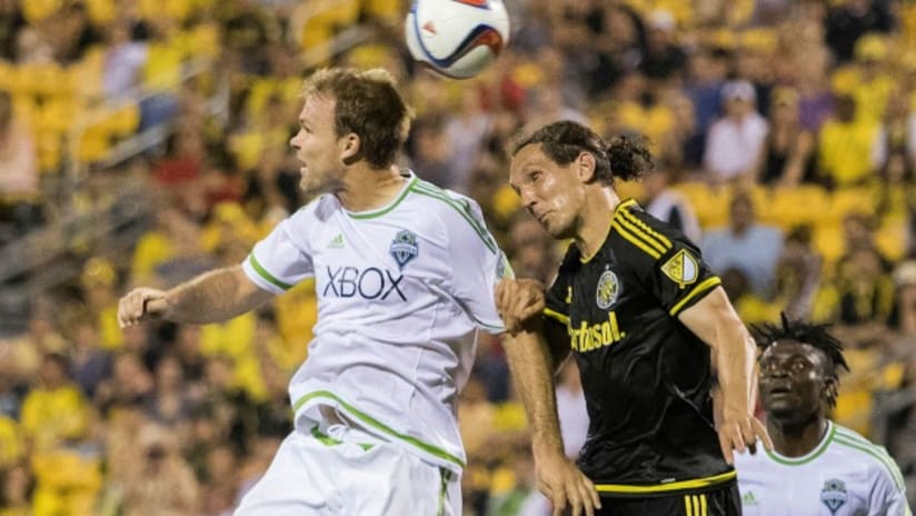 Columbus Crew SC's Emmanuel Pogatetz battles with Seattle Sounders Chad Marshall