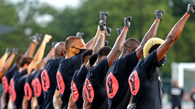 Black Players for Change - fists up back to camera